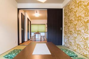 a dining room with a table and chairs at Bijou Suites Kakomi in Osaka