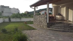 a porch of a house with a stone wall at Nina Villa in Rab