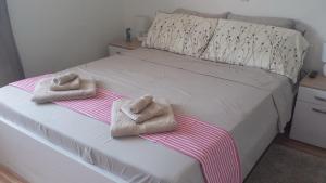 a bedroom with a bed with towels on it at Nina Villa in Rab