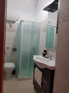 een badkamer met een douche, een wastafel en een toilet bij Bed and breakfast Marilena in Montegiordano
