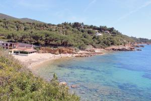 a view of a beach with people in the water at Villa Oleandro in Capoliveri