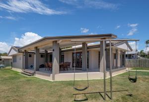 a house with a porch with swings at Home at Southside Central in Bundaberg