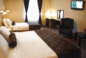 Ένα ή περισσότερα κρεβάτια σε δωμάτιο στο Belgrade City Hotel