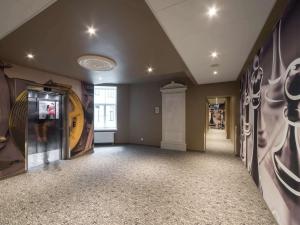 a hallway with a room with paintings on the walls at Ibis Riga Centre in Rīga