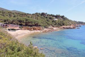 a view of a beach with people in the water at Villa Cedro in Capoliveri
