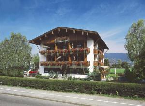 a building with lots of plants and flowers on it at Hotel-Pension-Ostler in Bad Wiessee