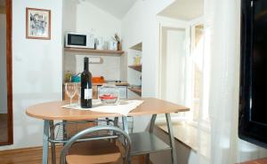 a table with a bottle of wine and two glasses at Apartment Old Town Gverovic in Dubrovnik