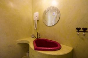 a bathroom with a red sink and a mirror at La Dolce Vita Residence - Romantic Boutique Stay for Couples, Veli Lošinj Old Town in Veli Lošinj +30 photos