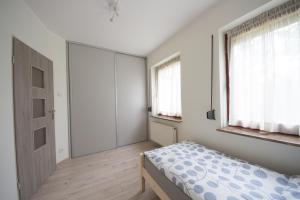 Posteľ alebo postele v izbe v ubytovaní Apartament Zebcowska