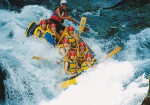 a group of people in a raft in a river at Pension Rapan in Katashina