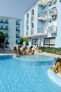 a group of people sitting in a swimming pool at Adriatico Family Village in Gatteo a Mare