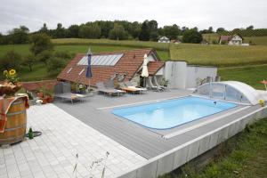 a swimming pool on a deck next to a house at Sonnenwiese in Unterlamm 58 in Unterlamm