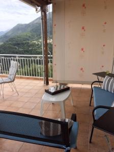 a balcony with chairs and a table and a view at Christos House in Kariá