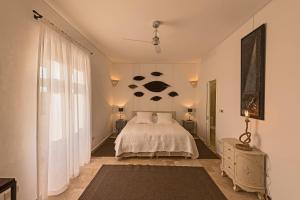 a bedroom with a bed and two lamps and a window at The Snop House in Senglea