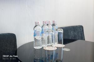 a group of water bottles sitting on top of a table at Mays Hotel- Ben Thanh in Ho Chi Minh City