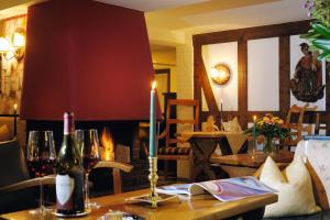 a table with a candle and two bottles of wine at Hotel Jagdhaus Wiese in Schmallenberg