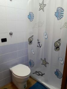 
a bathroom with a toilet and a shower curtain at FLY to NAPOLI in Naples
