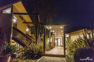 a house with a wooden pathway leading to the front door at Sandpiper Motel Apollo Bay in Apollo Bay