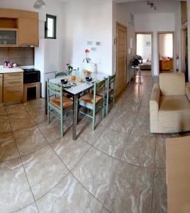 a kitchen and living room with a table and chairs at Sofokleous Apartment in Kavála