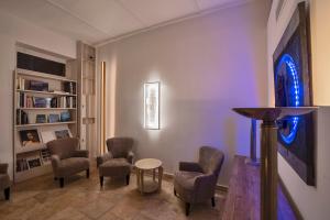 a living room with chairs and a table in a room at The Snop House in Senglea