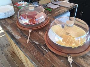 a counter with two plates of food and spoons on it at Anissaras Beach Appartement in Hersonissos