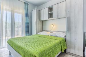 En eller flere senge i et værelse på Apartments & Bungalows Ivanović