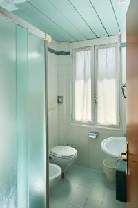 a bathroom with a toilet and a sink at Hotel Croce Di Malta in Imperia