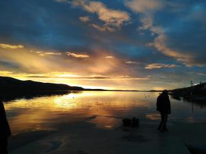 a person standing on the shore of a body of water at LARA & VITO in Metajna