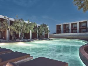 a swimming pool in front of a building at Olea All Suite Hotel in Tsilivi