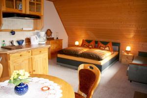 a kitchen and a bedroom with a bed and a table at Ferienzimmer Hämer in Prerow