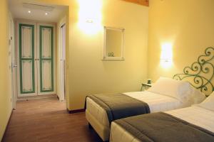 Ένα ή περισσότερα κρεβάτια σε δωμάτιο στο Hotel Borgo Antico