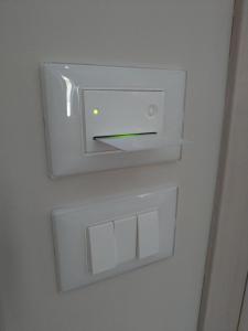 a white lightswitch on a wall in a room at B&B Nonna Irene in Matino