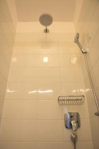 a shower in a bathroom with a shower head at Apartment Villa Franci in Pag