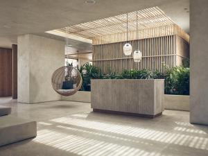 a lobby with a reception desk and potted plants at Olea All Suite Hotel in Tsilivi