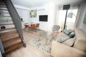 a living room with a couch and a table at Feelathome Mártires Apartments in Málaga