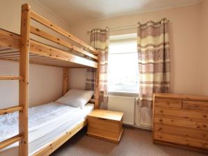 a bedroom with two bunk beds and a window at Spacious Holiday Home in Wismar Germany with Parasol in Wismar