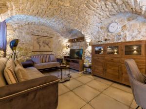 a living room with a stone wall at Villa ZEN in Tribalj