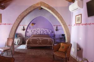 a bedroom with a bed in a purple room at B&B Polirone in San Benedetto Po