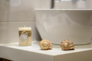 two oysters sitting on a shelf next to a candle at Ormos Holiday Studios in Naxos Chora +35 photos