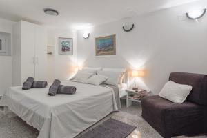Postel nebo postele na pokoji v ubytování Apartments Lodra