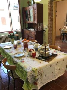 a dining room table with a table cloth on it at B&B Polirone in San Benedetto Po