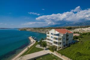 an aerial view of a building next to the water at Apartments Vila 4m in Ražanac