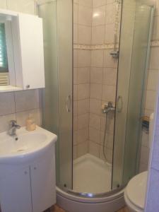 a bathroom with a shower and a sink at House Krk in Krk +21 photos