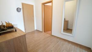 a room with a mirror and a wooden floor at Apartment Ana in Vinjerac +24 photos