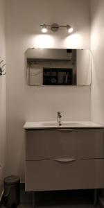 a bathroom with a sink and a mirror at Nice Seaview Free Parking 4.Pers in Nice