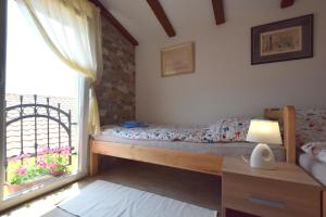 Postel nebo postele na pokoji v ubytování Apartments Neven