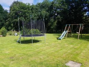 two swings and a trampoline in a park at Maison 6 chambres au cœur du circuit des 24h du Mans in Mulsanne