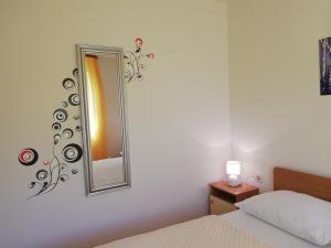 a bedroom with a mirror on the wall at Apartmani Marija in Primošten
