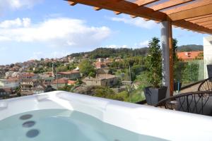 a hot tub on the balcony of a house at Desconectate in Aldán