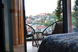 a balcony with a bed and a view of a city at Desconectate in Aldán